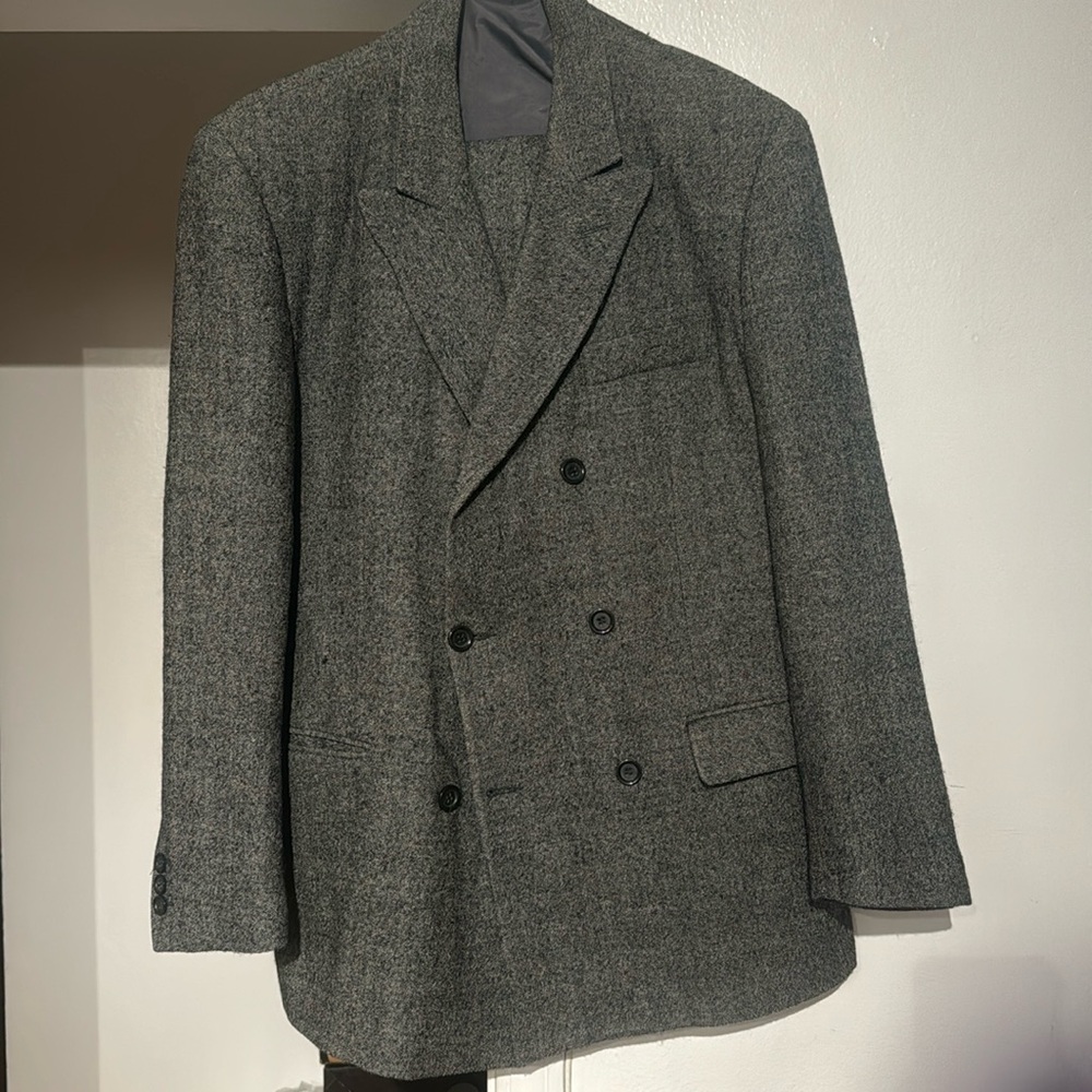 This is a 2 piece men suit. The suit is a grey 100% wool suit.